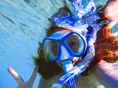 Underwater perspective of a girl snorkeling