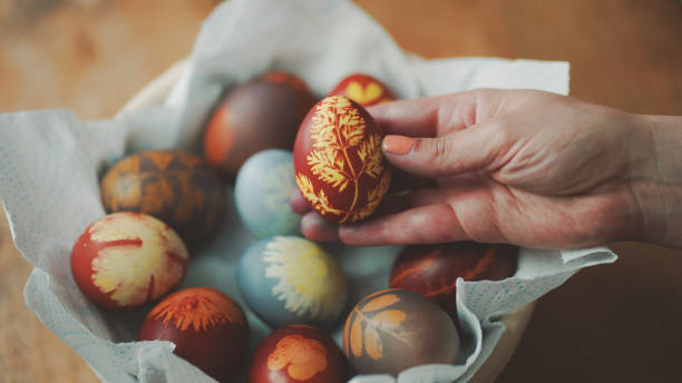 istock Easter Eggs decoration, hands showing decorations on Easter eggs placed in basket on wooden table 01 1392202826