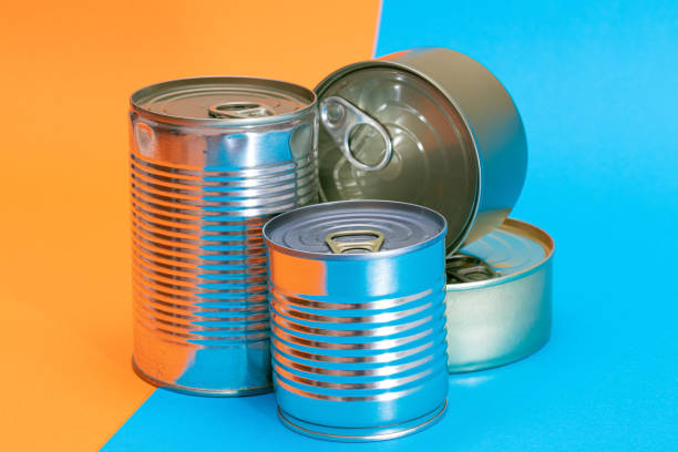 istock A Group of Stacked Tin Cans with Blank Edges on Split Blue and Orange Background 1392203441