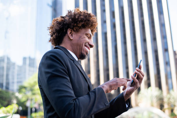 istock Brazilian man working and using technology in the city 1392205236