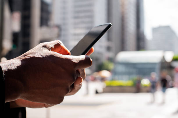 istock Brazilian man working and using technology in the city 1392205333