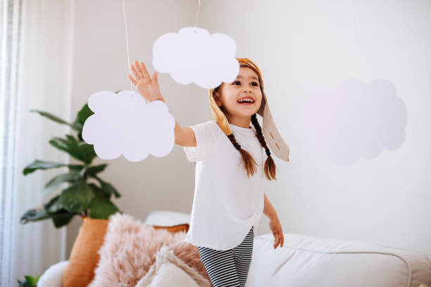 istock Little girl wearing a vintage pilot hat 1392207183