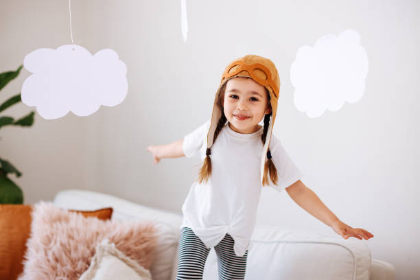 istock Little girl wearing a vintage pilot hat 1392208344