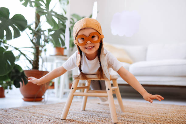 istock Little girl wearing a vintage pilot hat 1392208370