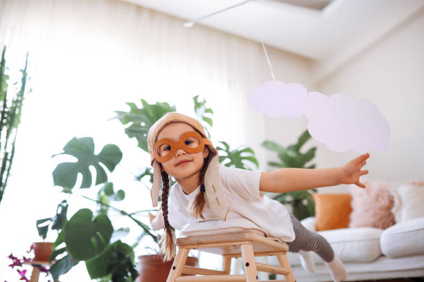 istock Little girl wearing a vintage pilot hat 1392208410