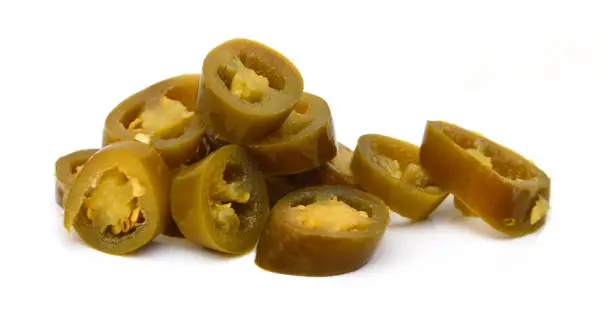 Slices of preserved Jalapeno pepper on a white background