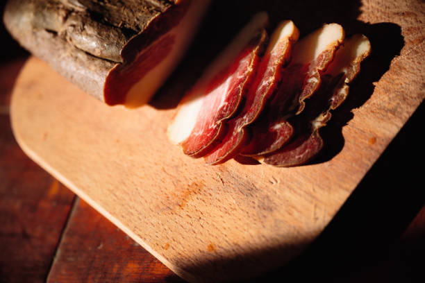 istock Bacon cured on a wooden board in the sun 1392211219