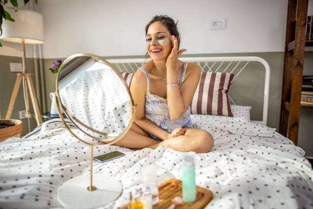 istock Smiling woman applying face cream 1392211372