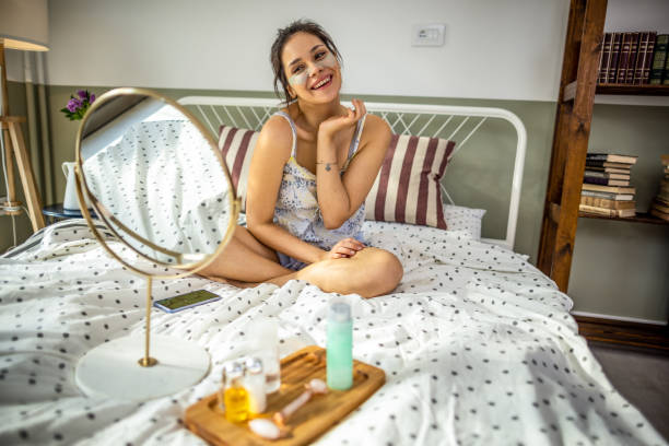 istock Smiling woman applying face cream 1392212415