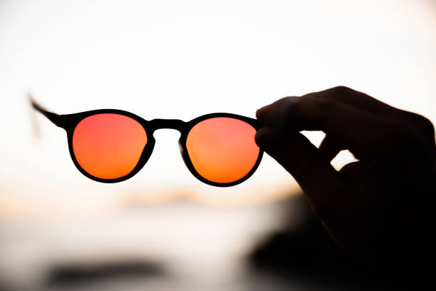 istock Orange Red Sunglasses Against Seychelles Beach Sunset 1392214539