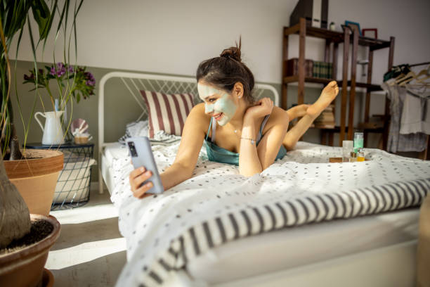 istock Woman using mobile phone in a bed 1392214583