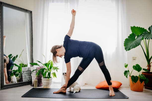 istock Young woman doing exercises at home 1392215936