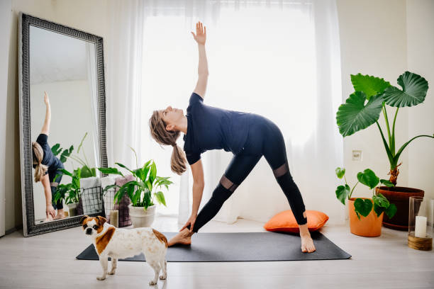 istock Young woman doing exercises at home 1392215937