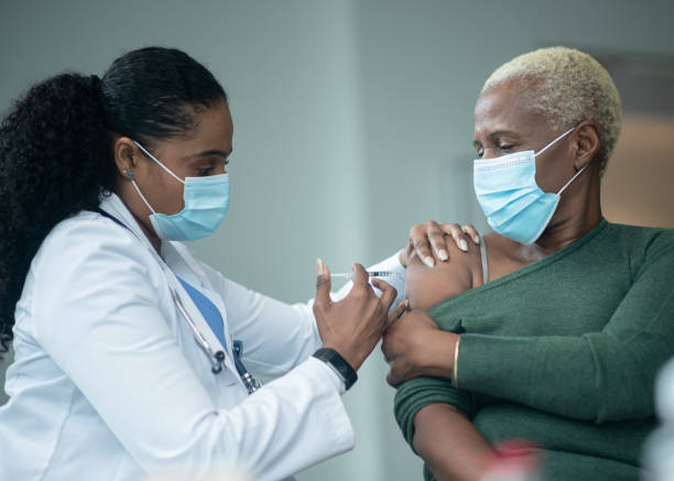 istock Senior Woman Receiving her Vaccination 1392216094