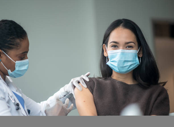 istock Woman Receiving a Vaccination 1392216110