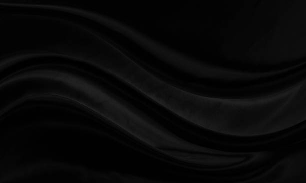 istock Black gray satin dark fabric texture luxurious shiny that is abstract silk cloth background with patterns soft waves blur beautiful. 1392216686