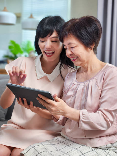istock Daughter show tablet to mom 1392217601