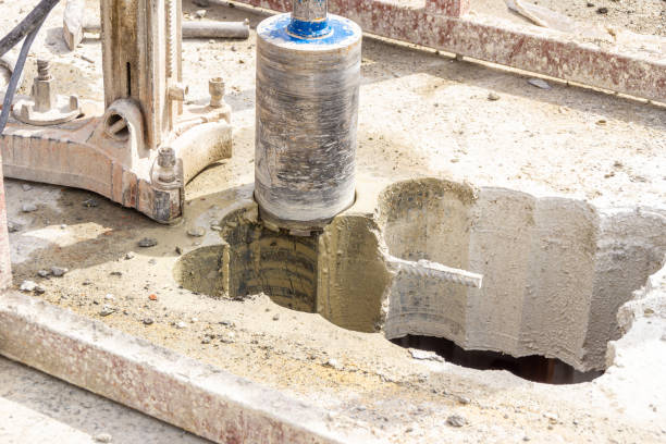 istock drilling holes in concrete floor or ceiling with drill rig and drill bit 1392217602