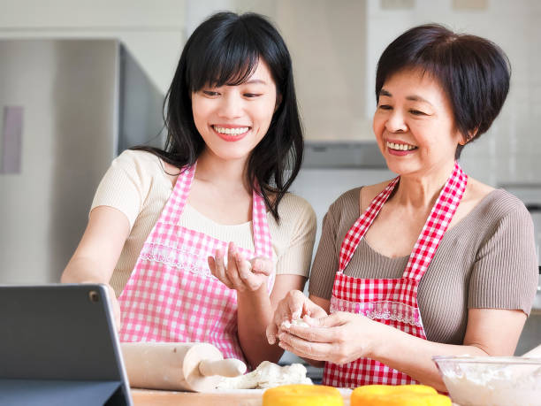 istock mom and daughter making bread 1392217616