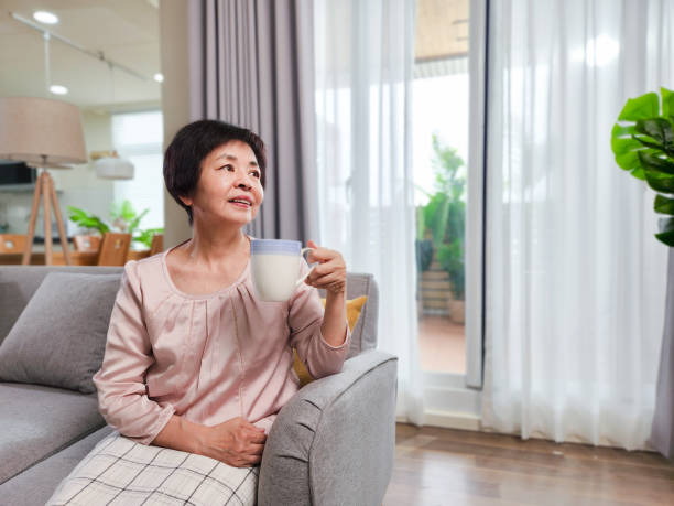 istock elderly woman drinking 1392217745
