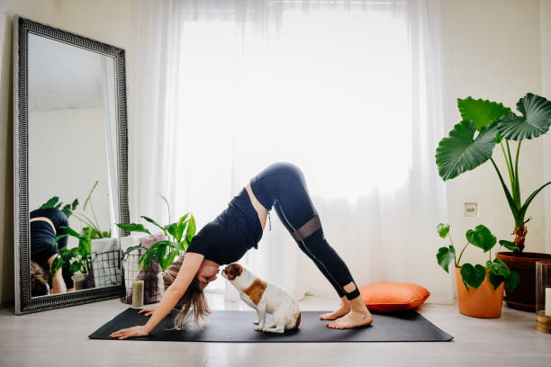 istock Young woman practicing yoga at home 1392218581