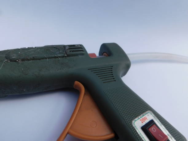 istock green hot glue gun, isolated on a white background 1392221556