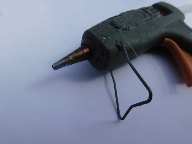 istock green hot glue gun, isolated on a white background 1392221584
