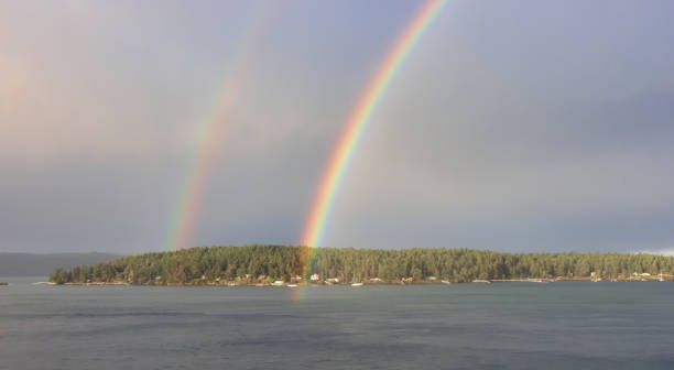 istock Double Rainbow in the cloudy sky over the pacific ocean and Gulf Islands 1392224735