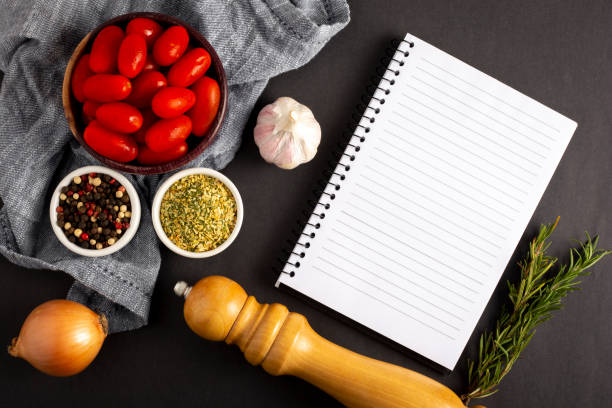 istock Cookbook with ingredients on the table.Recipe book. 1392224744