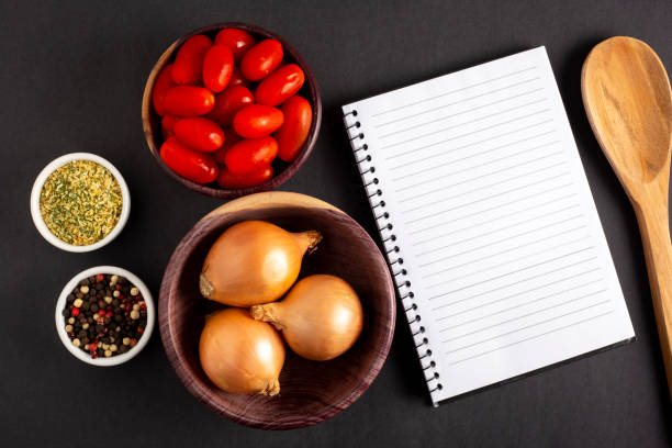 istock Cookbook with ingredients on the table.Recipe book. 1392224750