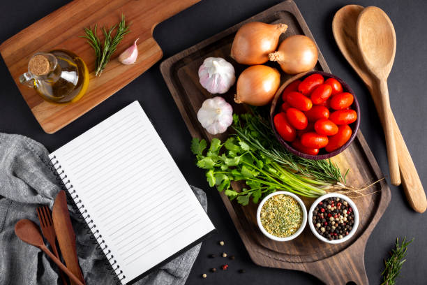 istock Cookbook with ingredients on the table.Recipe book. 1392224785