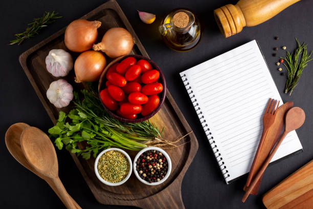 istock Cookbook with ingredients on the table.Recipe book. 1392224788