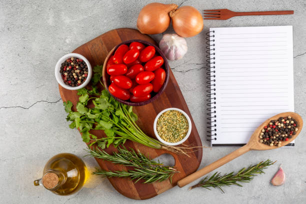 istock Cookbook with ingredients on the table.Recipe book. 1392224803