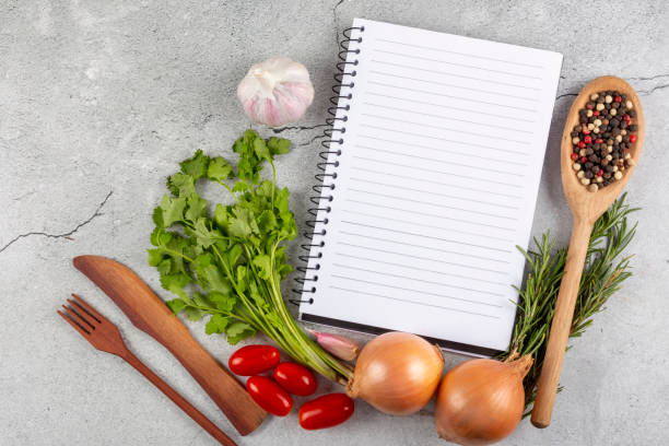 istock Cookbook with ingredients on the table.Recipe book. 1392224815