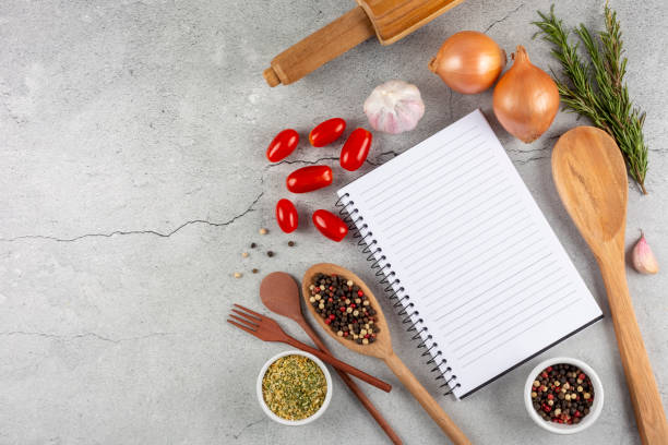 istock Cookbook with ingredients on the table.Recipe book. 1392224816