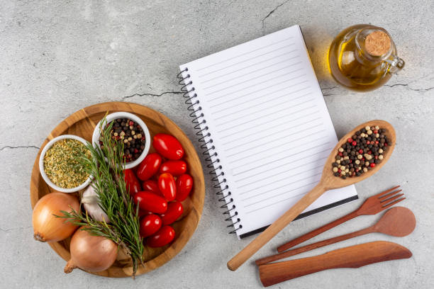 istock Cookbook with ingredients on the table.Recipe book. 1392224823