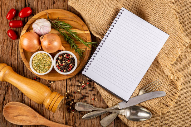 istock Cookbook with ingredients on the table.Recipe book. 1392224899