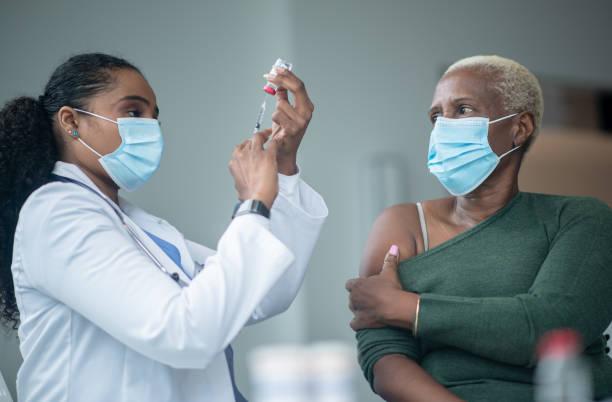 istock Senior Woman Preparing to Receive her Vaccination 1392226728