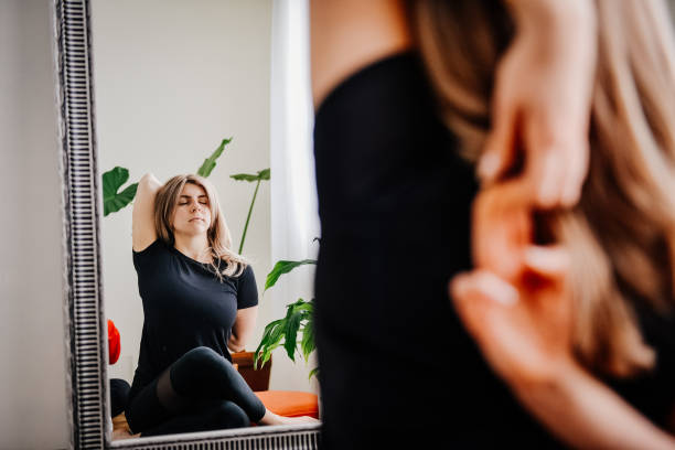 istock Women meditating in front of mirror 1392228183