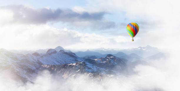 istock Dramatic Mountain Landscape and Hot Air Balloon Flying 1392230043