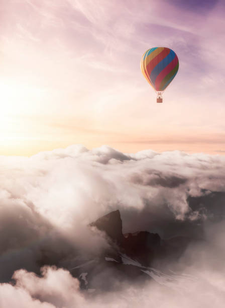 istock Dramatic Mountain Landscape and Hot Air Balloon Flying 1392230044