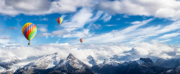 istock Dramatic Mountain Landscape and Hot Air Balloon Flying 1392230047