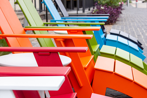A colorful metal  folding table and chair set on a brick patio