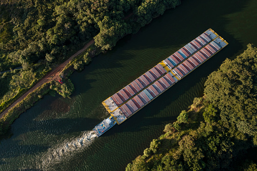 grain transport barge going up the tiete river - tiete-parana waterway - drone view