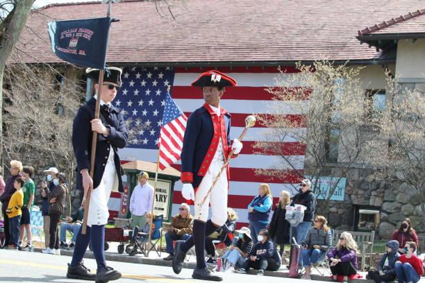 2022年4月18日にマサチューセッツ州レキシントンで開催された愛国者の日のパレード - child military saluting flag ストックフォトと画像