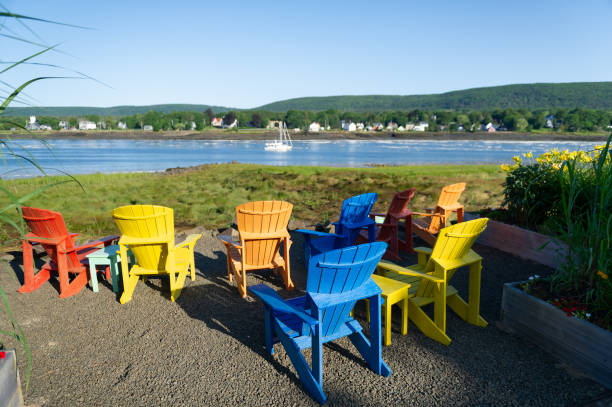 Multicolor Adirondack chairs facing the Bay of Fundy stock photo
