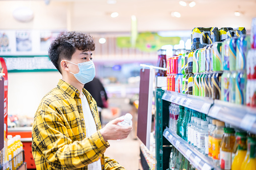 Asian young handsome man shopping in supermarket