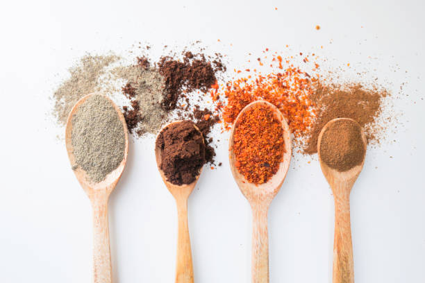 istock Various spices on wooden spoons on white background 1392244999