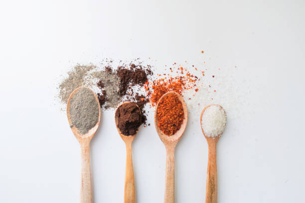 istock Various spices on wooden spoons on white background 1392245007