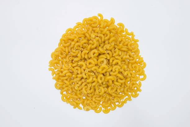 istock Top view of raw macaroni on white background. 1392246149